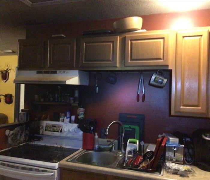 kitchen stove and cabinets damaged due to a fire
