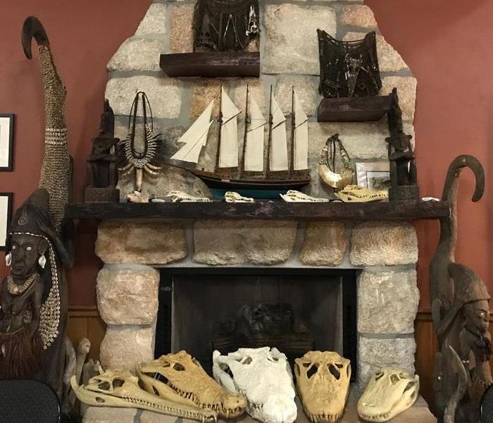 Group of alligator skulls around a fireplace