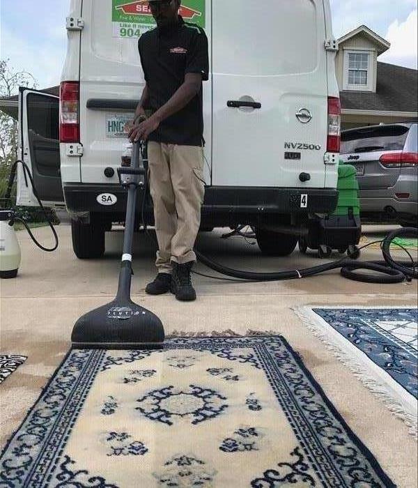 Male SERVPRO technician cleaning